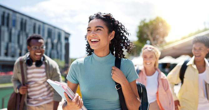 Student smiling and walking